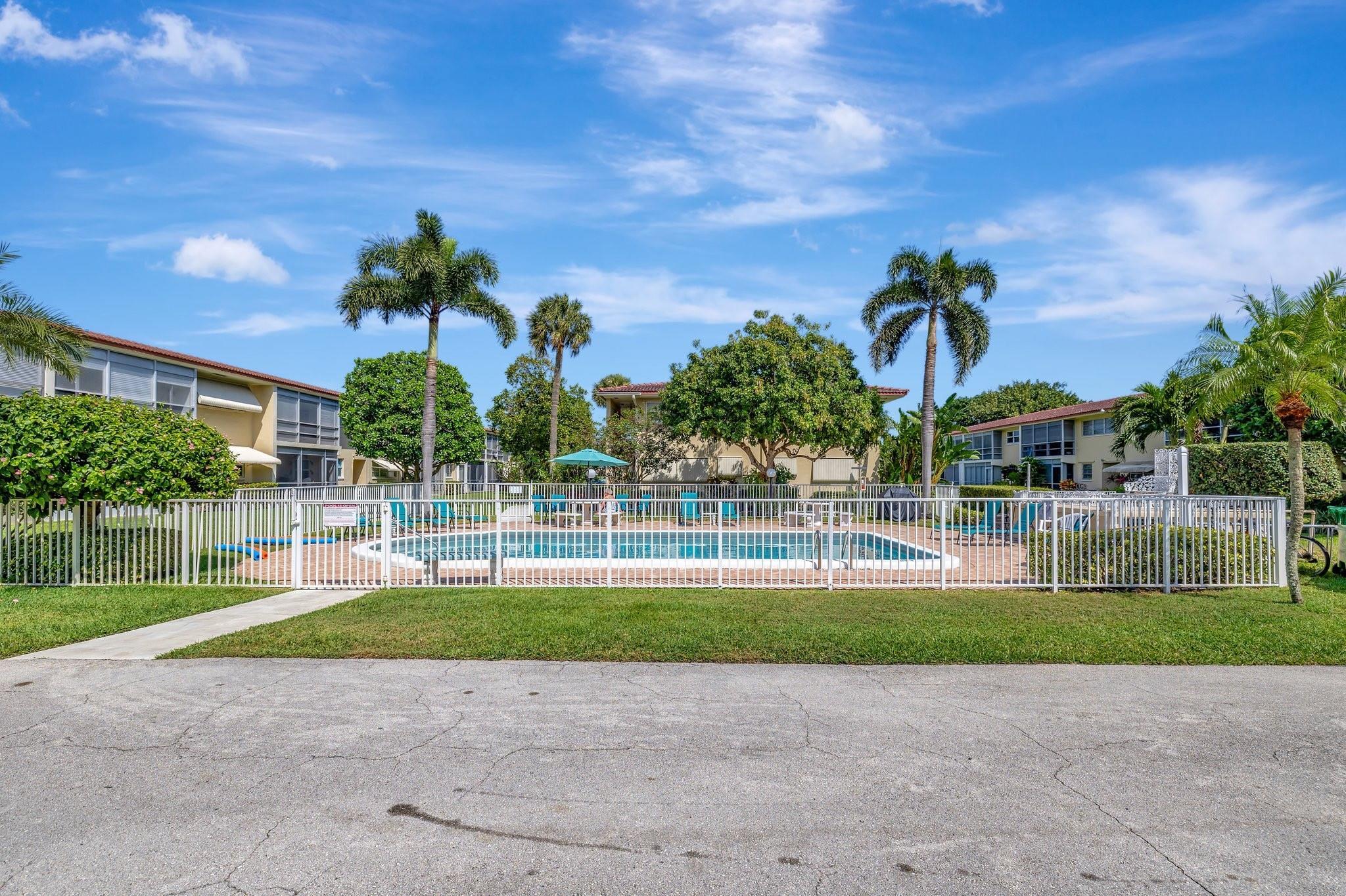 2134 Northeast 36th Street, Unit 82 Lighthouse Point, FL 33064 - Photo 33 of 38 a house with palm tree in front of it
