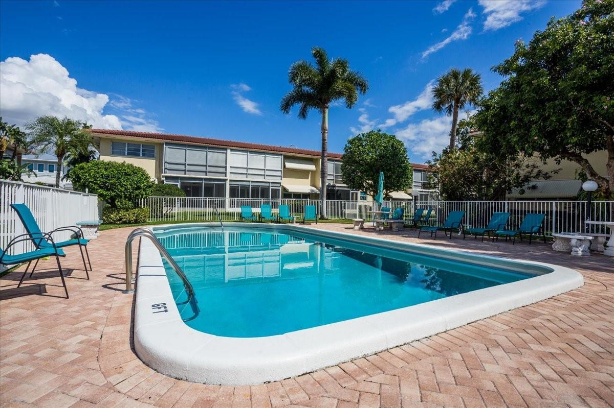 2134 Northeast 36th Street, Unit 82 Lighthouse Point, FL 33064 - Photo 35 of 38 a view of a swimming pool with a patio
