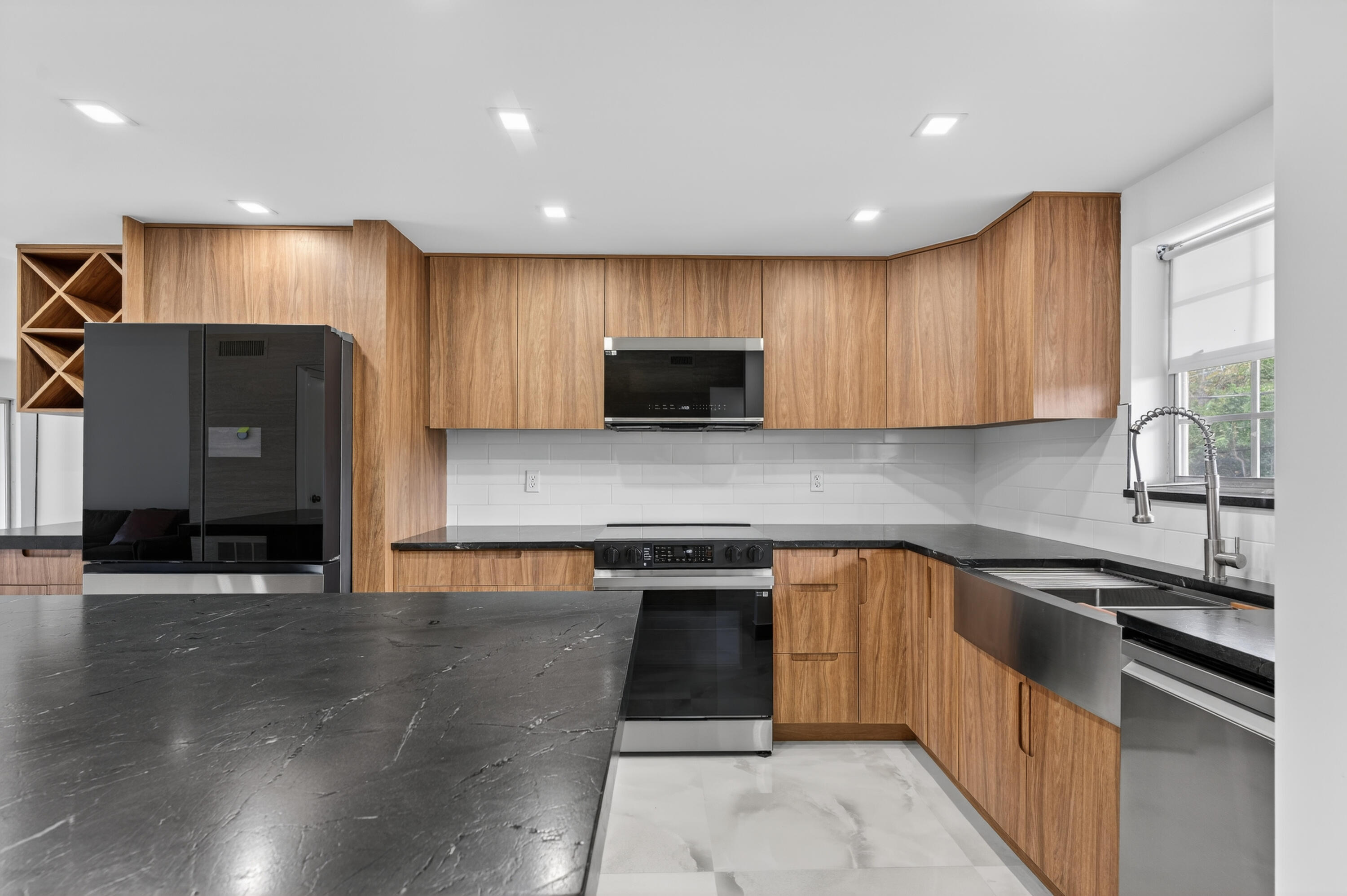2134 Northeast 36th Street, Unit 82 Lighthouse Point, FL 33064 - Photo 7 of 38 a kitchen with stainless steel appliances granite countertop a sink and a stove