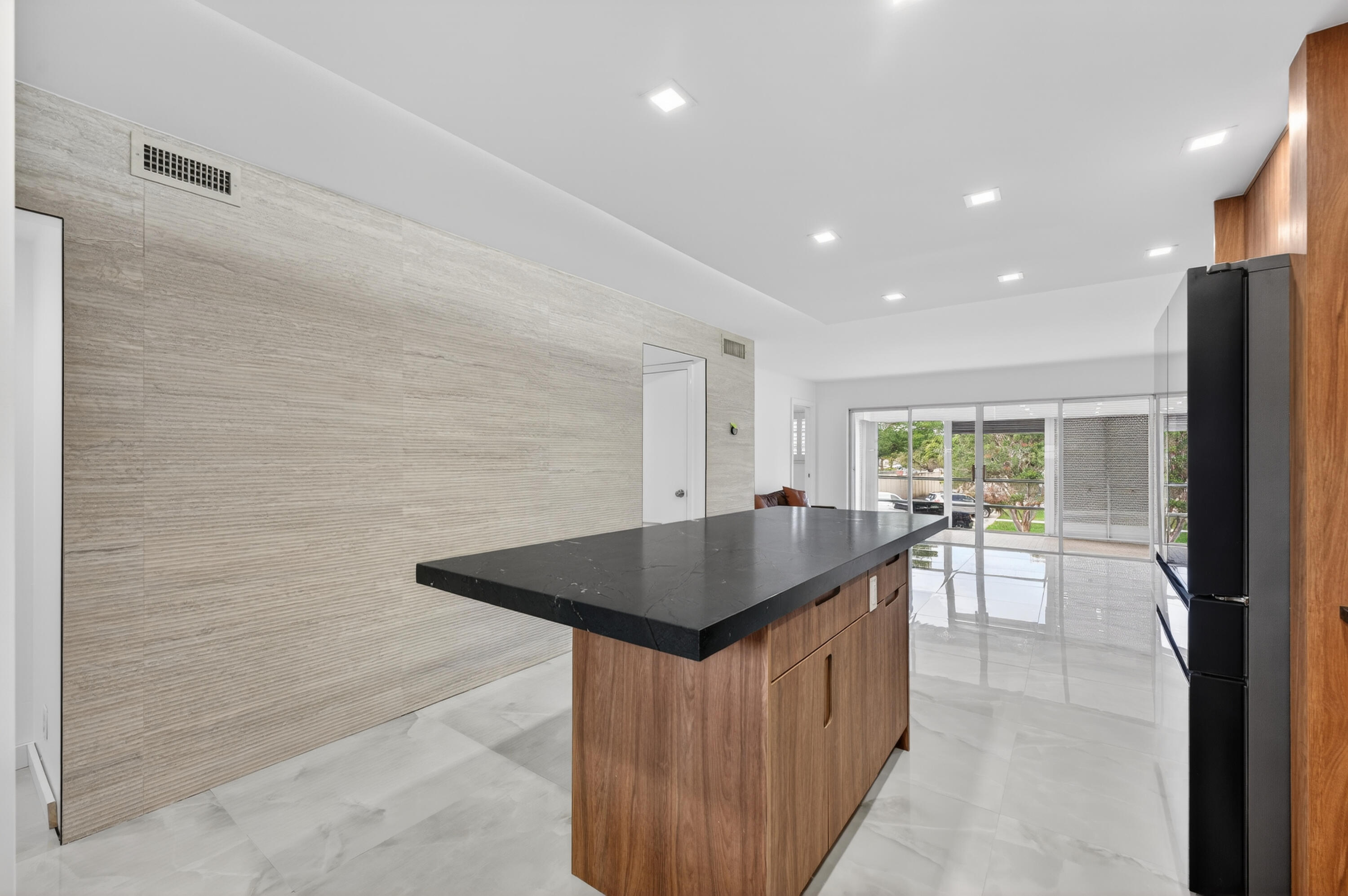2134 Northeast 36th Street, Unit 82 Lighthouse Point, FL 33064 - Photo 8 of 38 a kitchen with counter top space and windows