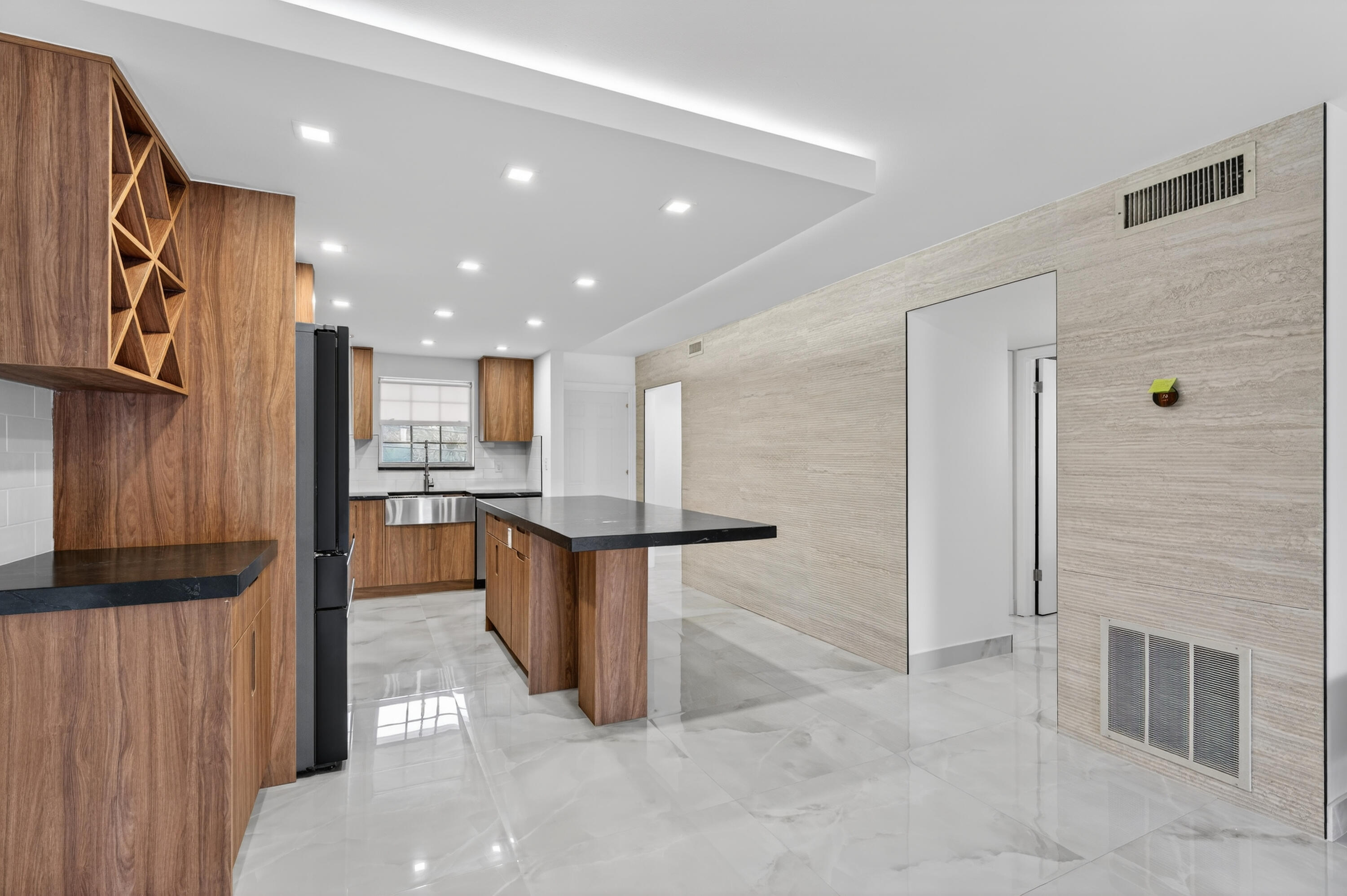 2134 Northeast 36th Street, Unit 82 Lighthouse Point, FL 33064 - Photo 9 of 38 a open kitchen with kitchen island granite countertop a refrigerator oven stove a sink and a island