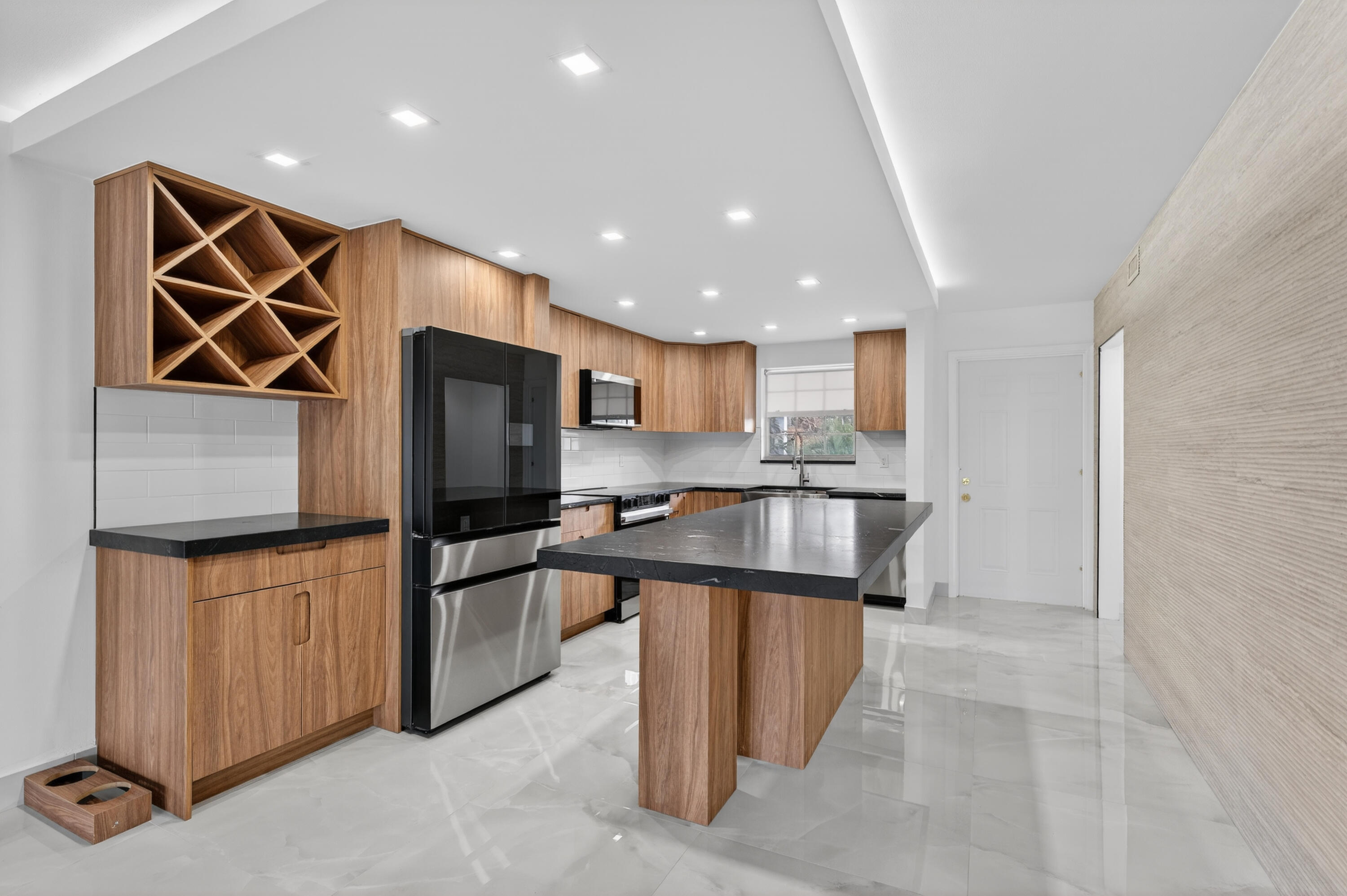 2134 Northeast 36th Street, Unit 82 Lighthouse Point, FL 33064 - Photo 10 of 38 a kitchen with stainless steel appliances granite countertop a refrigerator and a stove top oven