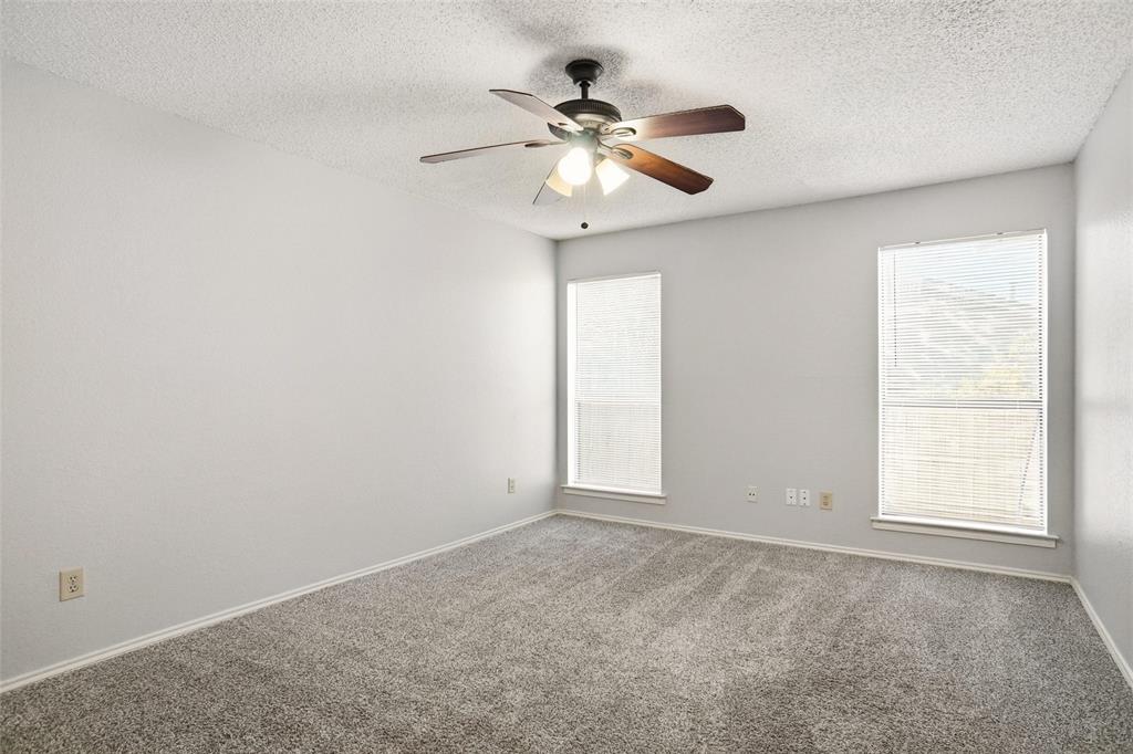6720 Crestmont Court Fort Worth, TX 76133 - Photo 8 of 16 an empty room with a window and a fan