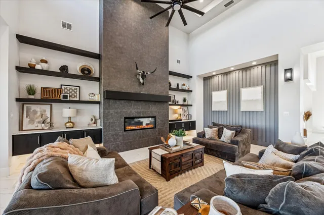 a living room with furniture fireplace and a window