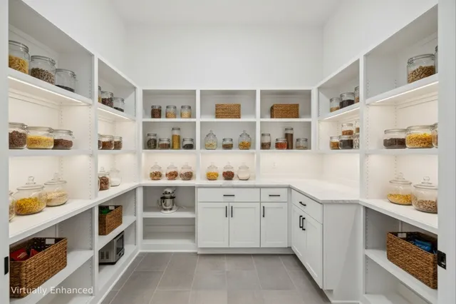 a kitchen with stainless steel appliances granite countertop a lot of cabinets and wooden floor