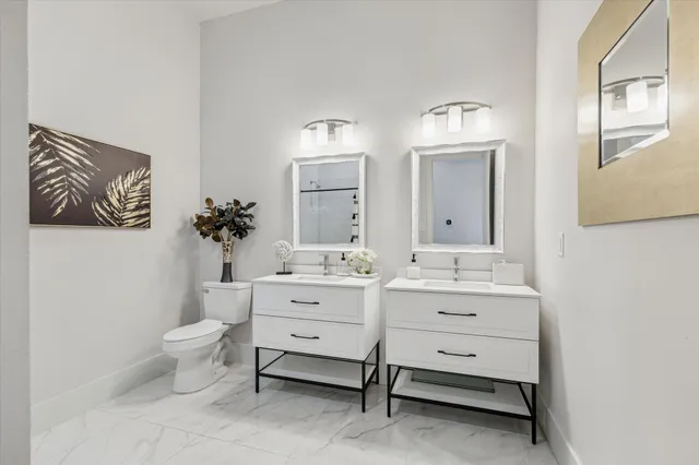 a spacious bathroom with a toilet sink and mirror