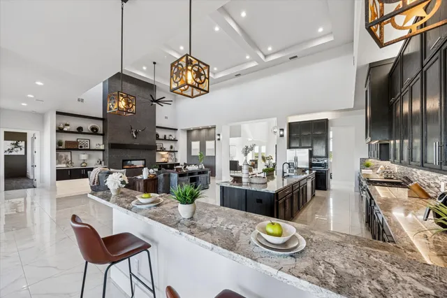 a view of a dining room and kitchen with a table chairs
