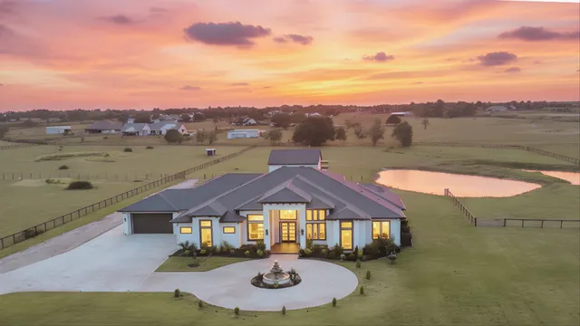 a view of a big house with a big yard