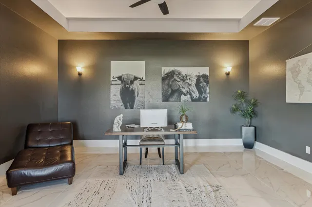 a work room with furniture and a potted plant
