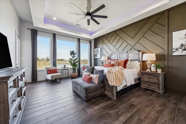 a bedroom with furniture and a flat screen tv