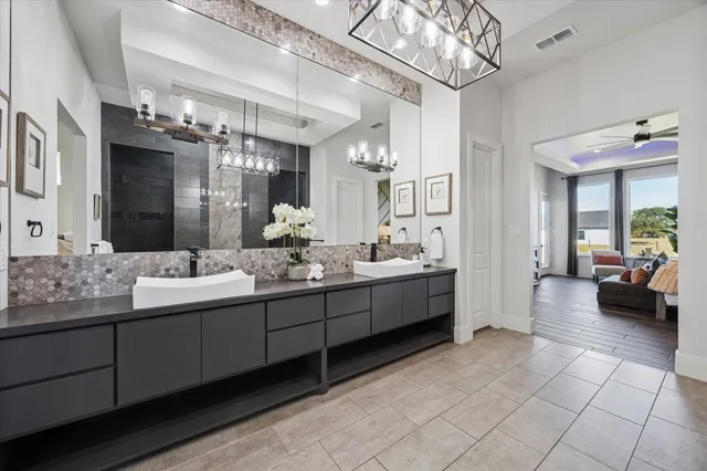 a bathroom with a sink a large mirror and a shower