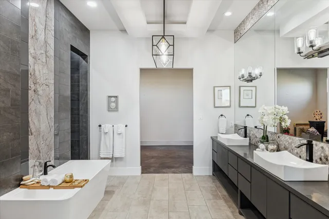 a bathroom with a tub sink and mirror