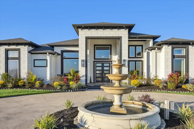 a front view of a house with a fountain