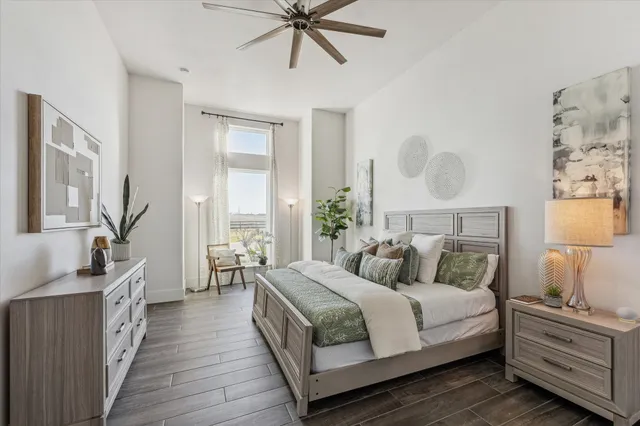 a bedroom with bed and wooden floor