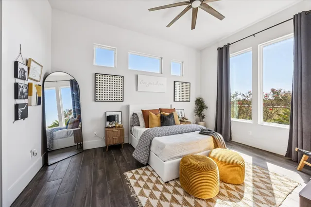a bedroom with furniture and a large window