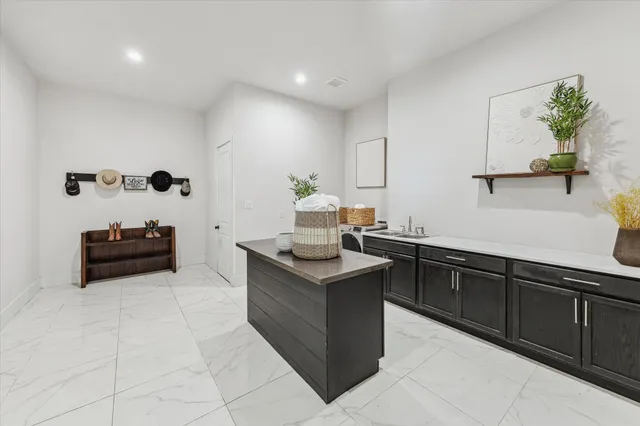 a kitchen with granite countertop a sink and a stove