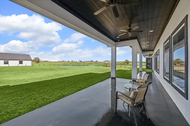 a view of a porch with furniture and garden