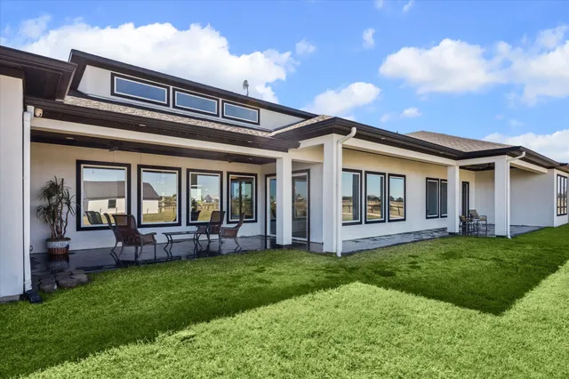 a front view of house with a garden and patio