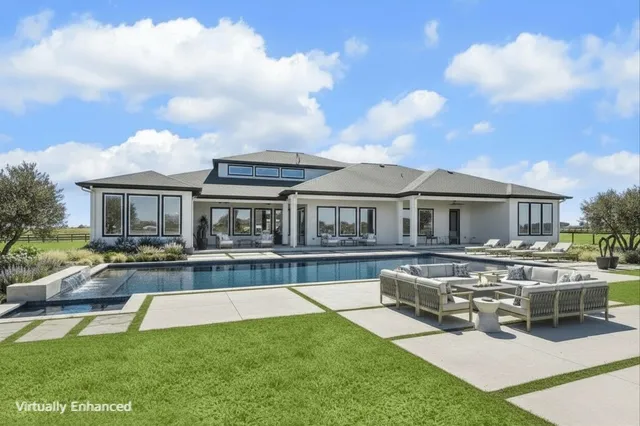 a front view of a house with swimming pool having outdoor seating