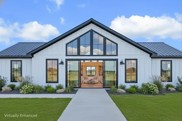 a view of a house with garage and chairs