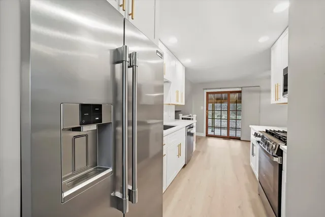 a kitchen with stainless steel appliances a refrigerator and a stove