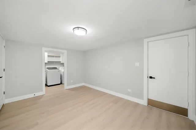 a view of a kitchen with a sink and a refrigerator