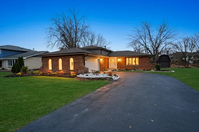 a view of house with yard and green space