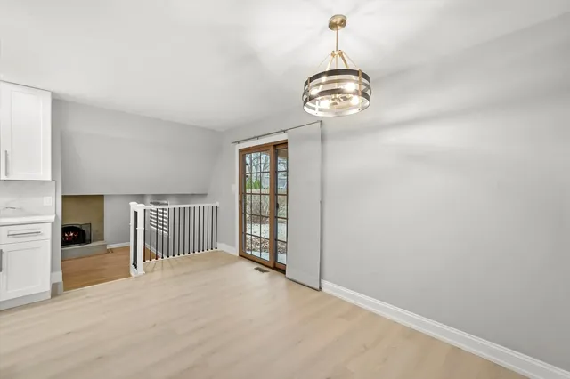 a view of a room with a large window and chandelier