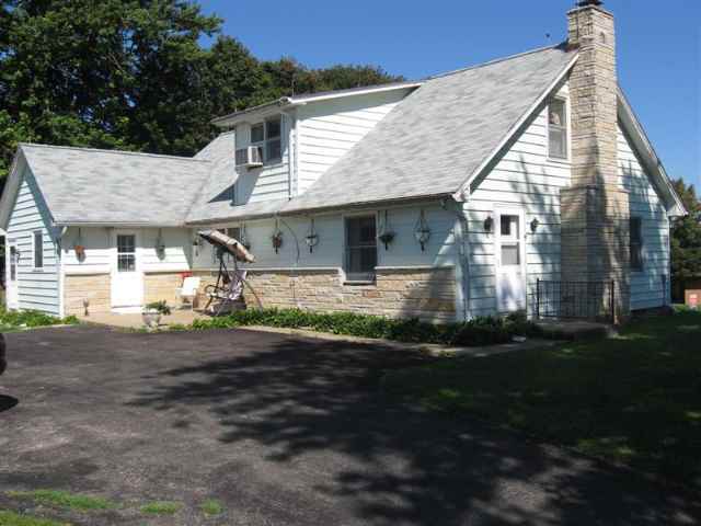 16983 Lyndon Road Morrison, IL 61270 - Photo 1 of 1 a front view of a house with a garden