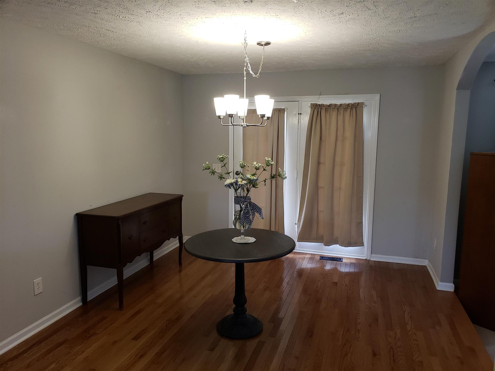 582 Windy Road Mount Juliet, TN 37122 - Photo 3 of 10 a view of a room with a chandelier and wooden floor