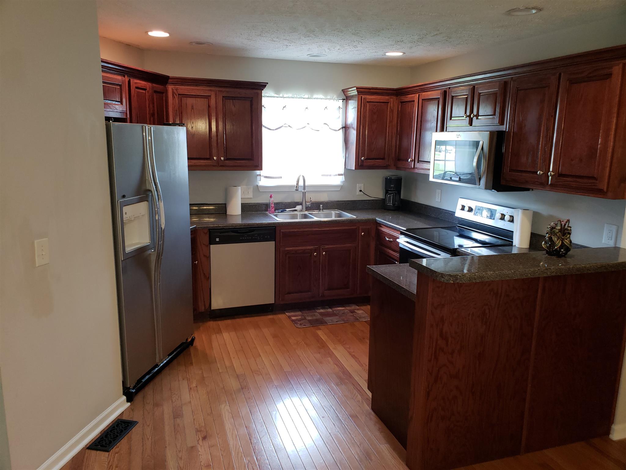 582 Windy Road Mount Juliet, TN 37122 - Photo 5 of 10 a kitchen with stainless steel appliances granite countertop refrigerator a sink and wooden cabinets