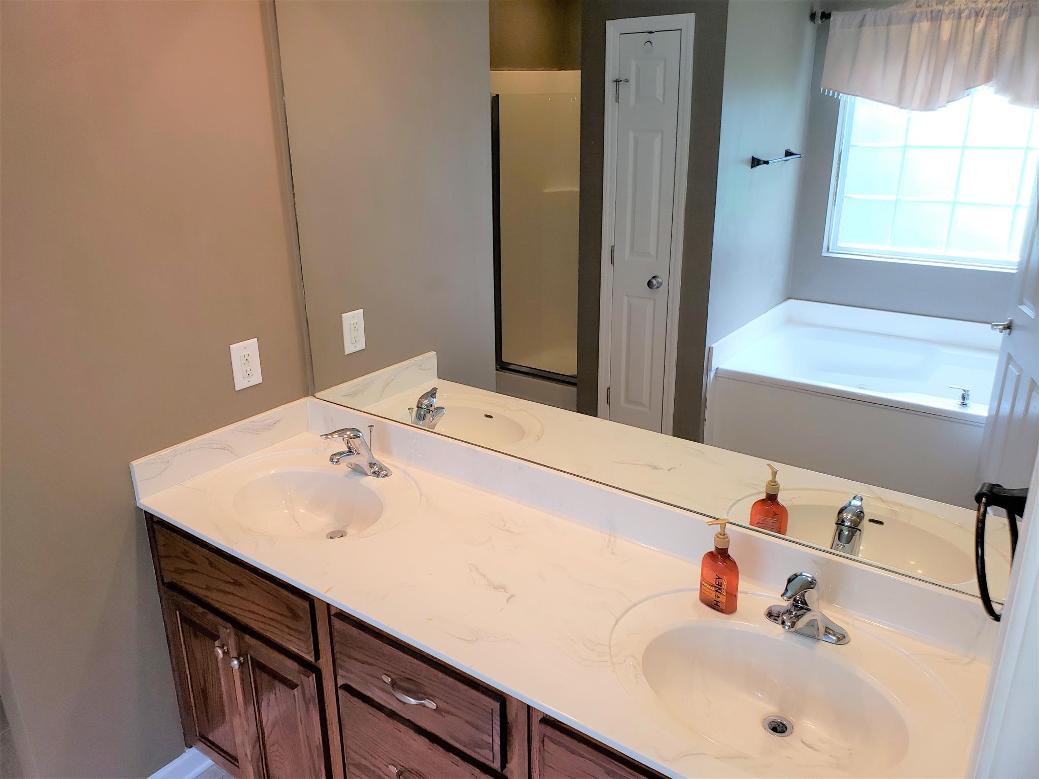 582 Windy Road Mount Juliet, TN 37122 - Photo 7 of 10 a bathroom with a sink and a large mirror