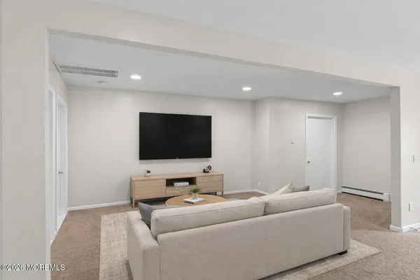 a spacious bedroom with a bed and a window