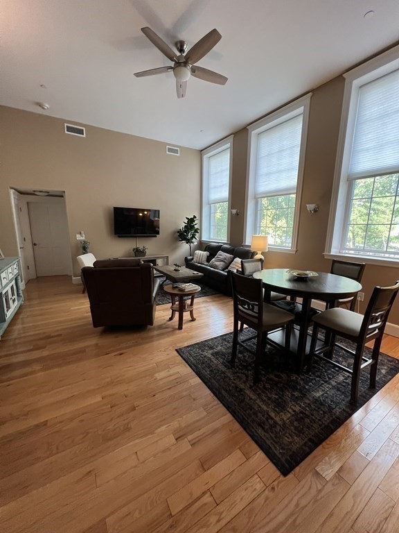 52 Sanborn Street, Unit 102 Reading, MA 01867 - Photo 13 of 28 a living room with furniture a window and a flat screen tv