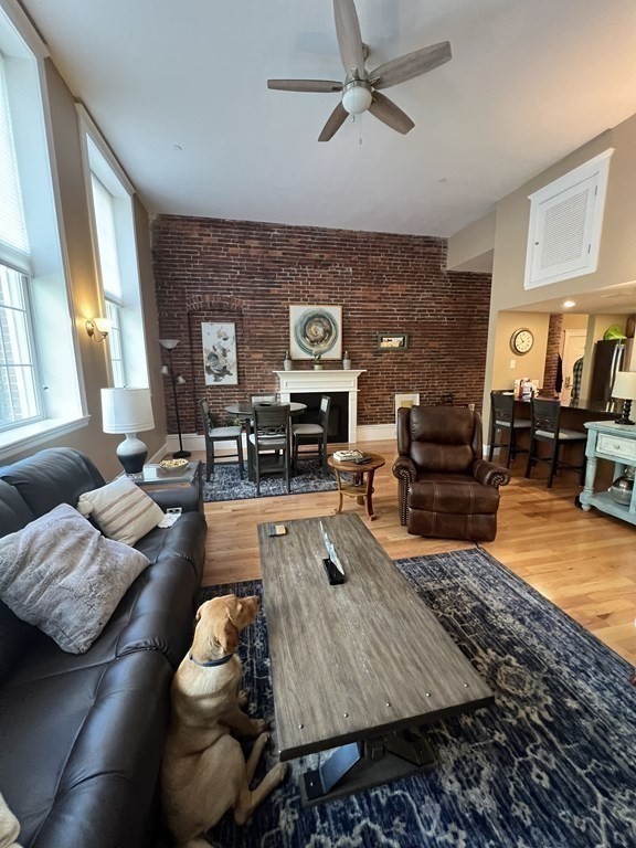 52 Sanborn Street, Unit 102 Reading, MA 01867 - Photo 14 of 28 a living room with furniture and a flat screen tv
