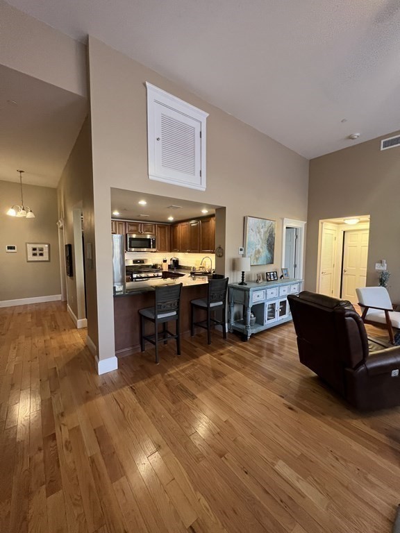 52 Sanborn Street, Unit 102 Reading, MA 01867 - Photo 18 of 28 a living room with furniture and kitchen view