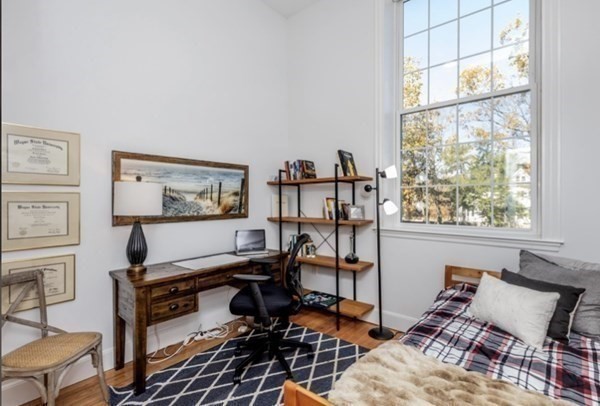 52 Sanborn Street, Unit 102 Reading, MA 01867 - Photo 20 of 28 a workspace with wooden floor and a window