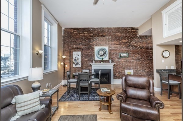 52 Sanborn Street, Unit 102 Reading, MA 01867 - Photo 22 of 28 a living room with furniture and a fireplace