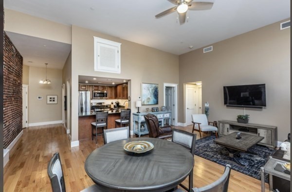 52 Sanborn Street, Unit 102 Reading, MA 01867 - Photo 23 of 28 a living room with furniture and a flat screen tv