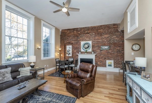52 Sanborn Street, Unit 102 Reading, MA 01867 - Photo 24 of 28 a living room with furniture and a fireplace