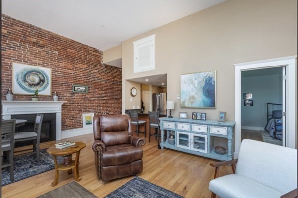 52 Sanborn Street, Unit 102 Reading, MA 01867 - Photo 25 of 28 a living room with furniture and a fireplace