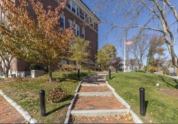 52 Sanborn Street, Unit 102 Reading, MA 01867 - Photo 26 of 28 a pathway of a house with a yard