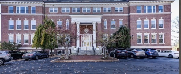 52 Sanborn Street, Unit 102 Reading, MA 01867 - Photo 28 of 28 a view of a brick building with many windows