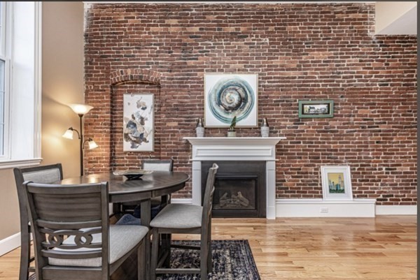 52 Sanborn Street, Unit 102 Reading, MA 01867 - Photo 6 of 28 a living room with a wooden floor