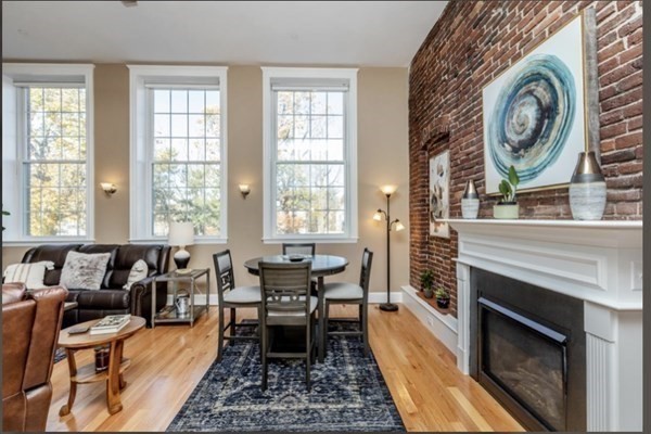 52 Sanborn Street, Unit 102 Reading, MA 01867 - Photo 7 of 28 a living room with furniture and a fireplace