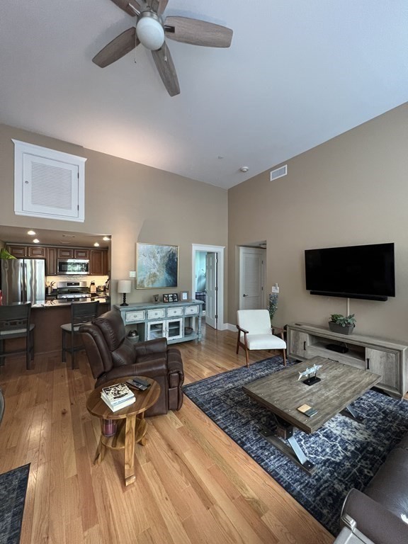 52 Sanborn Street, Unit 102 Reading, MA 01867 - Photo 9 of 28 a living room with furniture and a flat screen tv