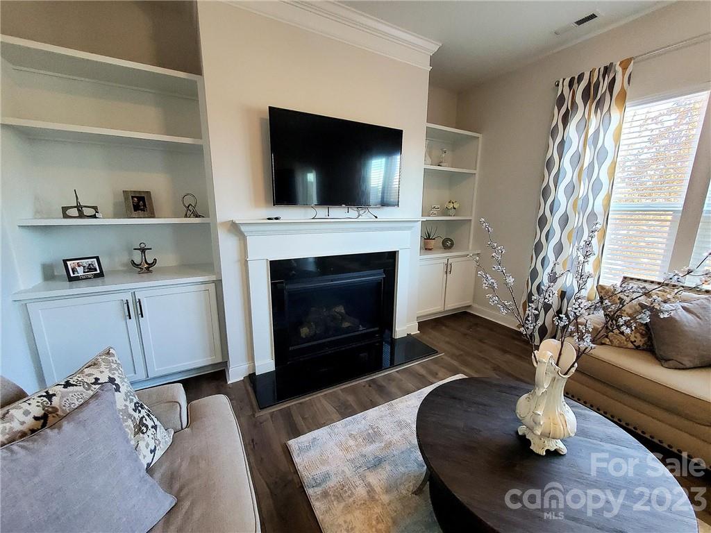 10013 Sunset Ridge Midland, NC 28107 - Photo 17 of 45 a living room with furniture a flat screen tv and a fireplace