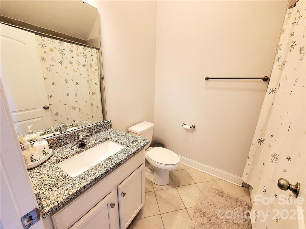 10013 Sunset Ridge Midland, NC 28107 - Photo 21 of 45 a bathroom with a granite countertop sink a toilet and shower