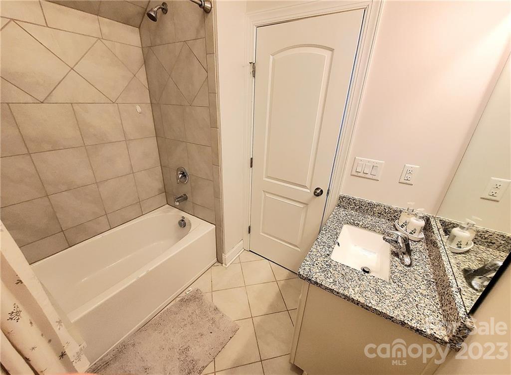 10013 Sunset Ridge Midland, NC 28107 - Photo 22 of 45 a bathroom with a bathtub and shower