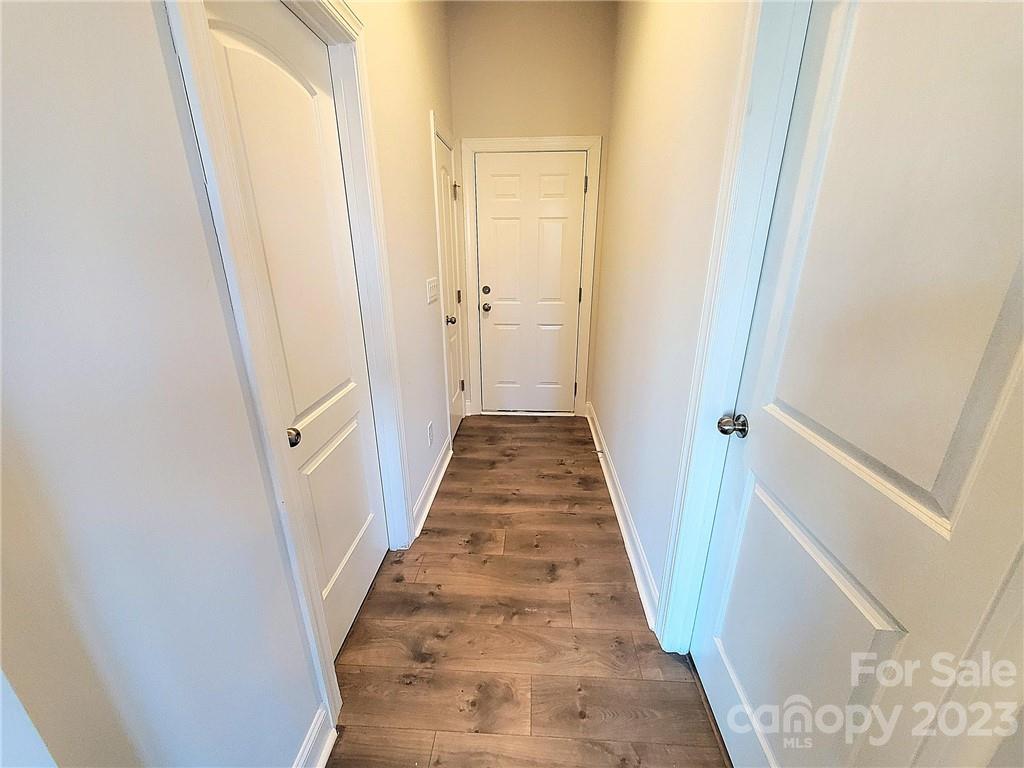 10013 Sunset Ridge Midland, NC 28107 - Photo 23 of 45 a view of a hallway with wooden floor and a bathroom